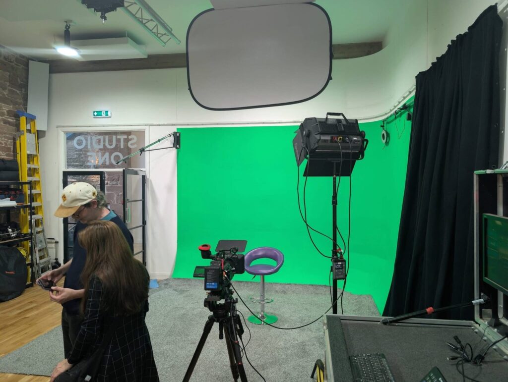 Camera set up in front of the green screen infinity cove during studio tours
